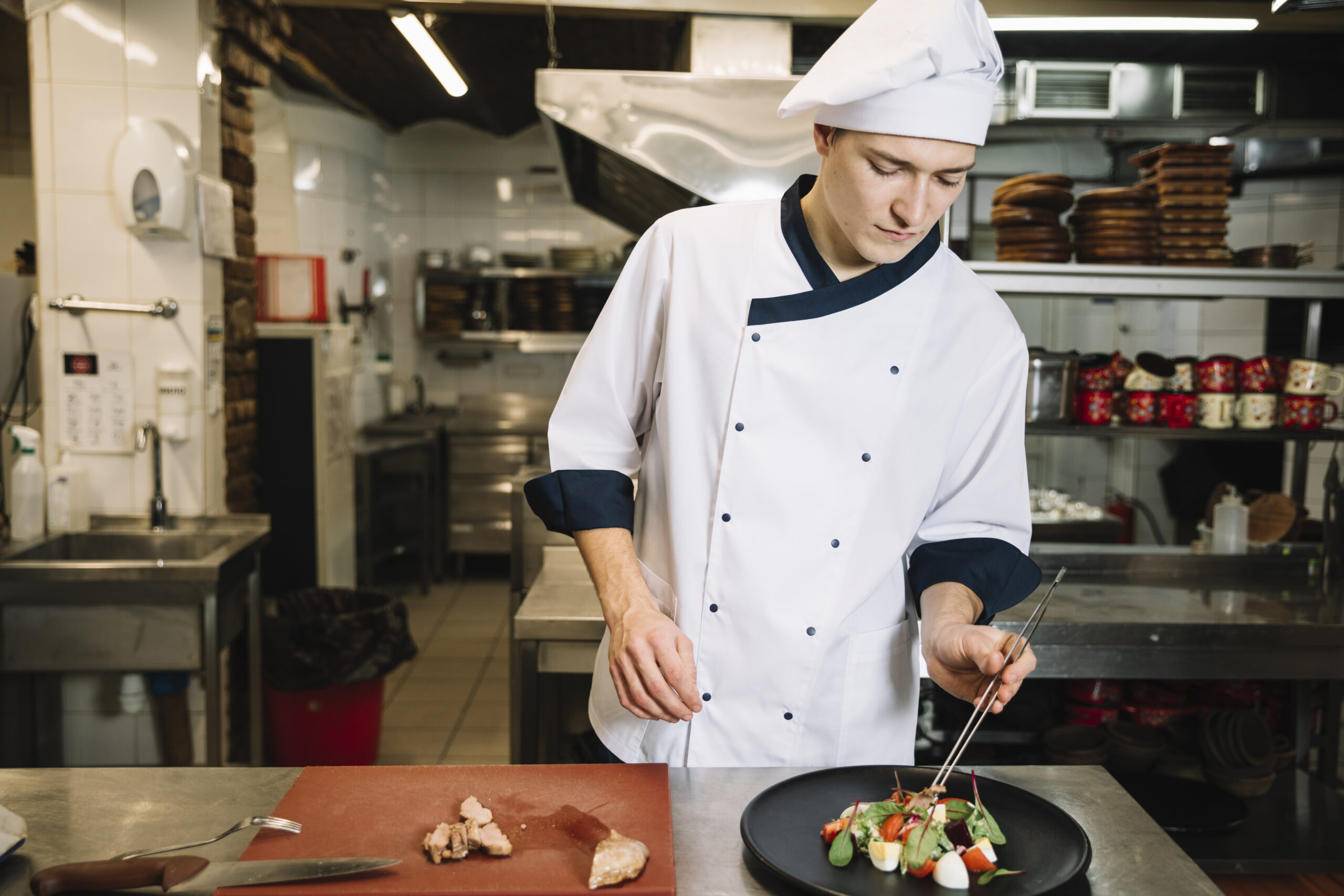 https://ataustralia.edu.au/wp-content/uploads/2024/05/cook-preparing-salad-with-meat-table-scaled.jpg